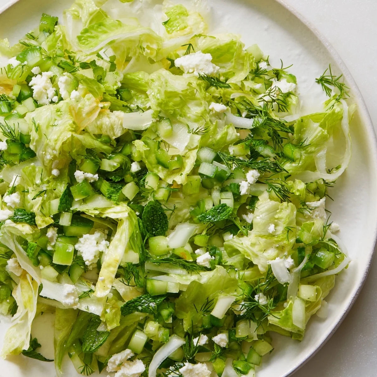 Vibrant Maroulosalata with tender romaine, fresh herbs, cucumber, and tangy lemon vinaigrette served as a light summer side