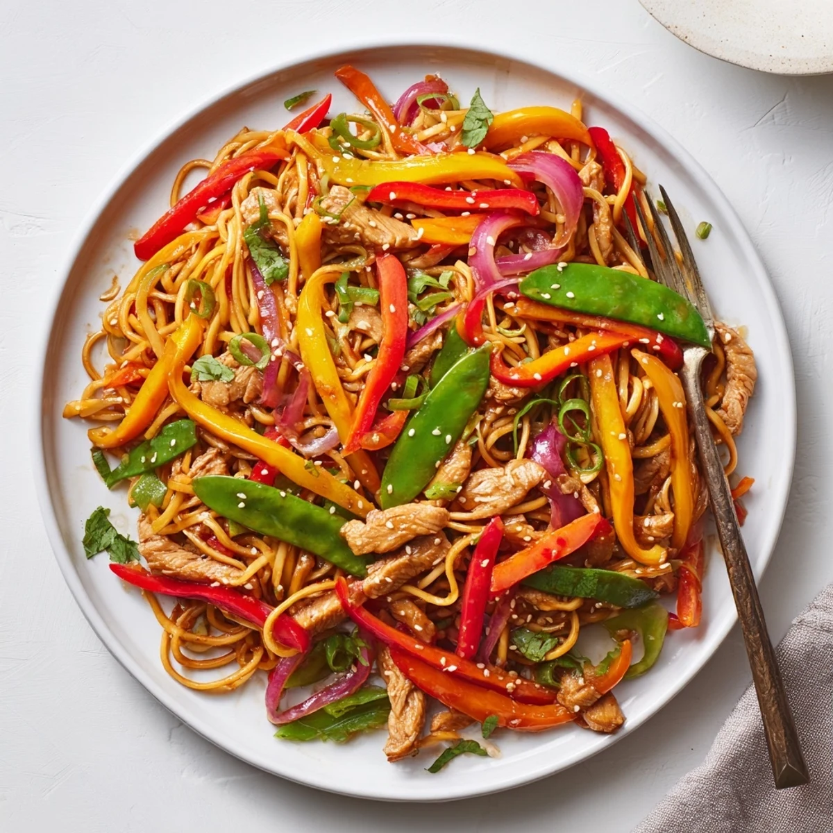 Wok-fried sweet chili turkey noodle stir fry with crisp bell peppers and tender sliced meat