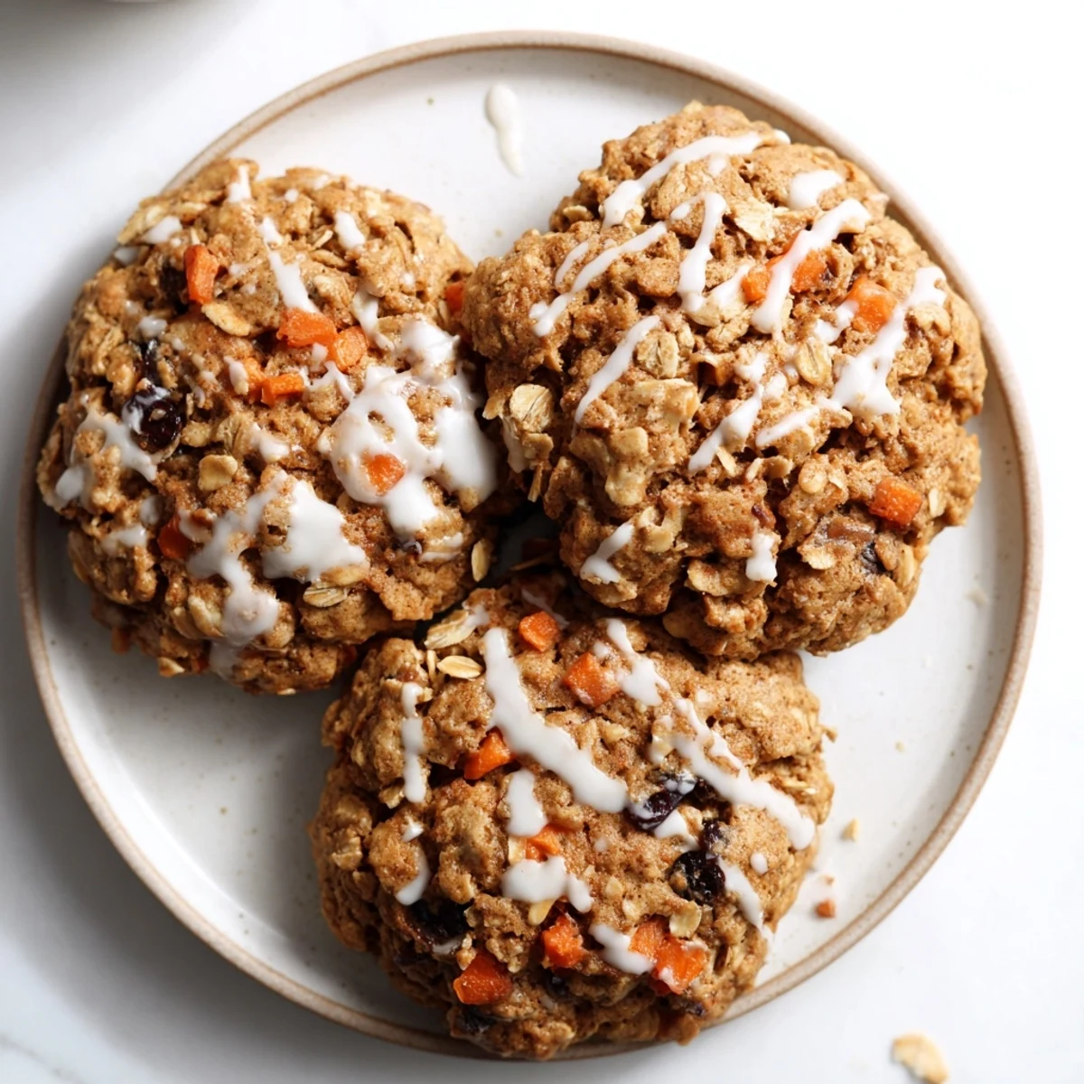Chewy brown butter carrot cake cookies with visible orange carrot shreds and toasted walnut pieces