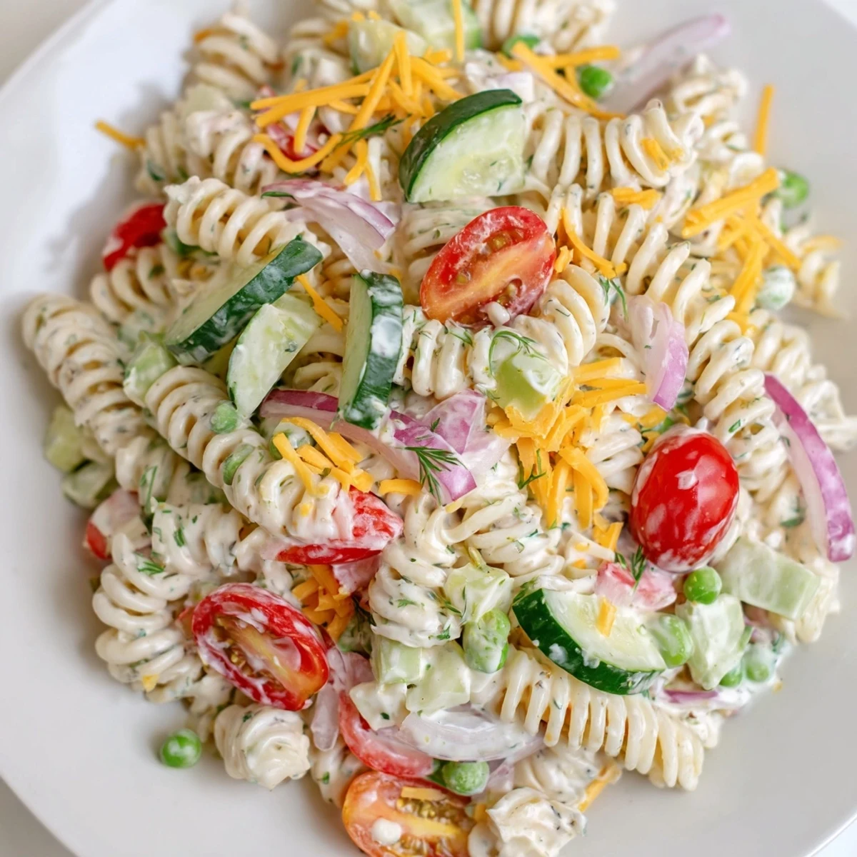 Chilled creamy ranch pasta salad featuring tender rotini bright veggies and fresh herbs