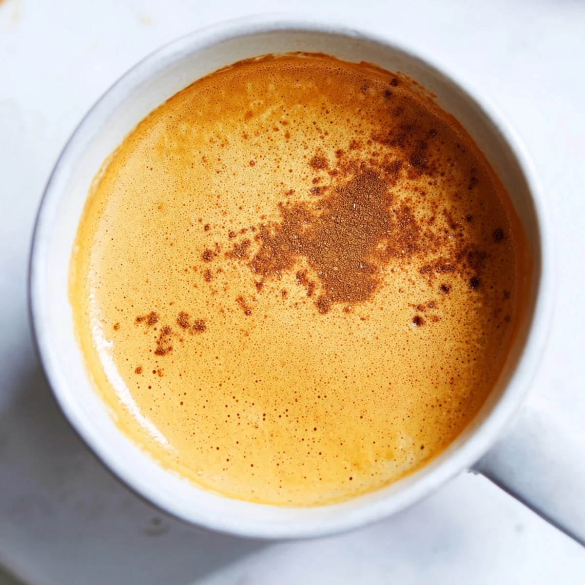Steaming Goguma Latte with a swirl of golden sweet potato and a dusting of nutmeg