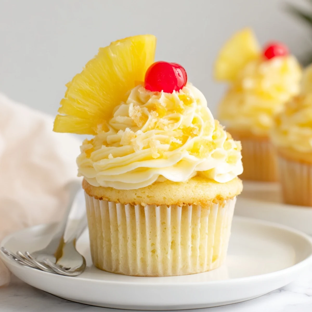 Dole Whip Cupcakes Recipe plated with yellow swirls, tropical aroma, and dried pineapple