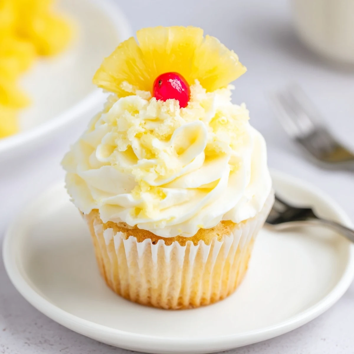 Bright Dole Whip Cupcakes Recipe with tangy cream cheese frosting and maraschino cherry