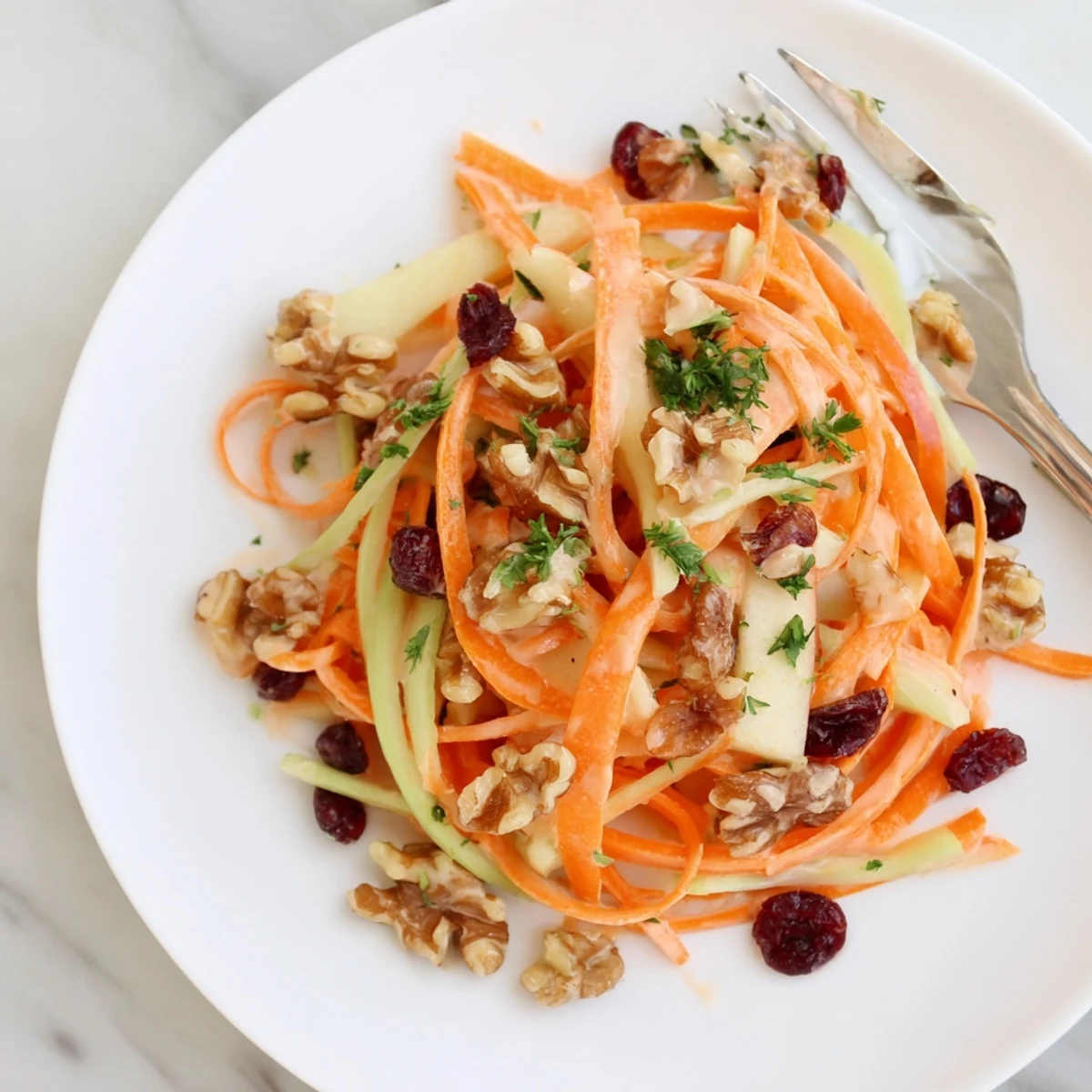 Crunchy Apple Carrot Salad With Creamy Citrus Dressing piled in wooden bowl, ready