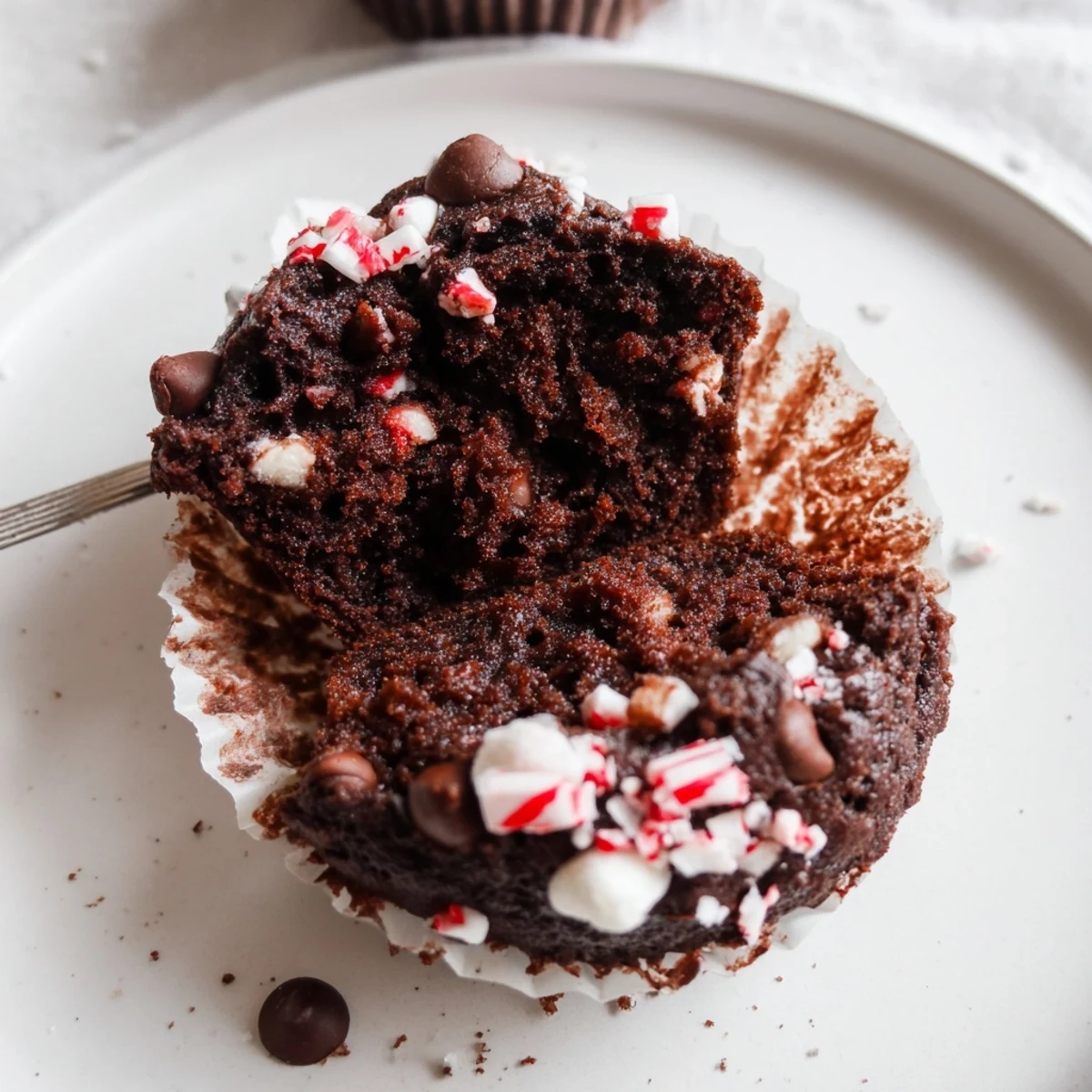 Plate of Peppermint Hot Chocolate Muffins served with whipped cream and cocoa
