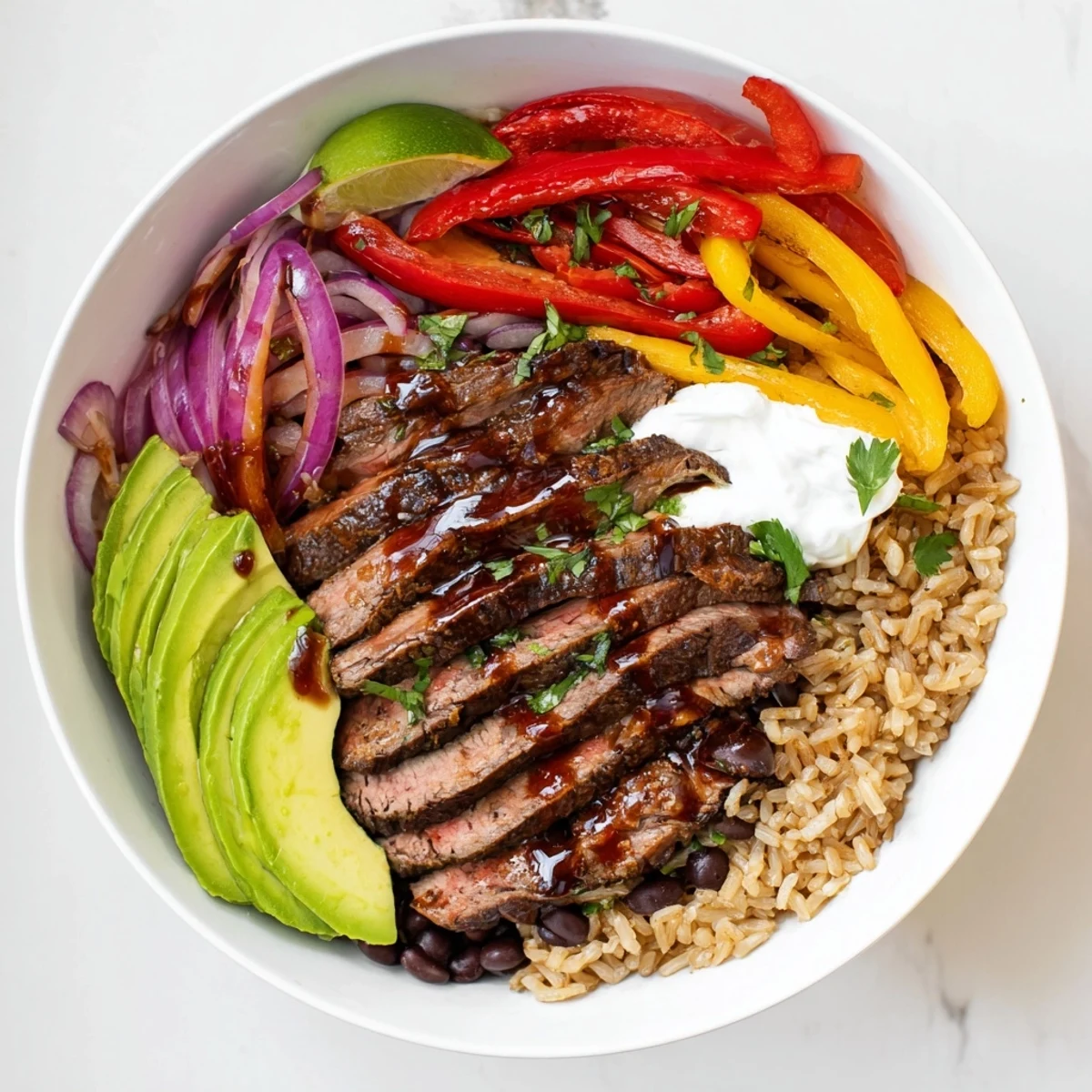 Steak Fajita Power Bowls with juicy marinated steak, charred peppers, lime