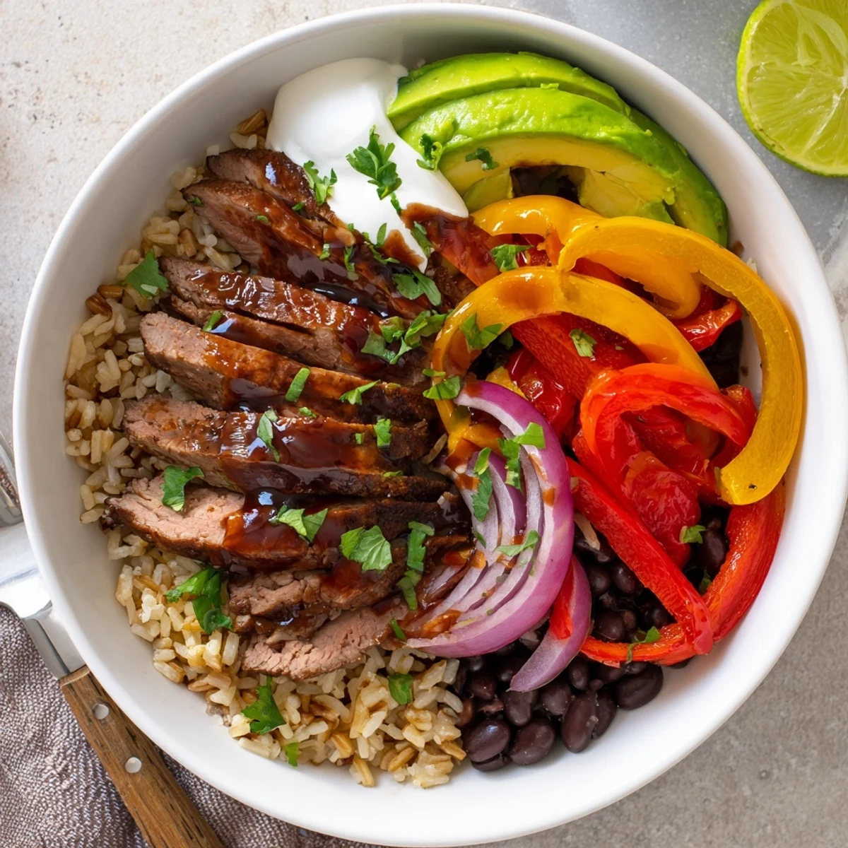 Weeknight-ready Steak Fajita Power Bowls steaming over rice, drizzled with lime