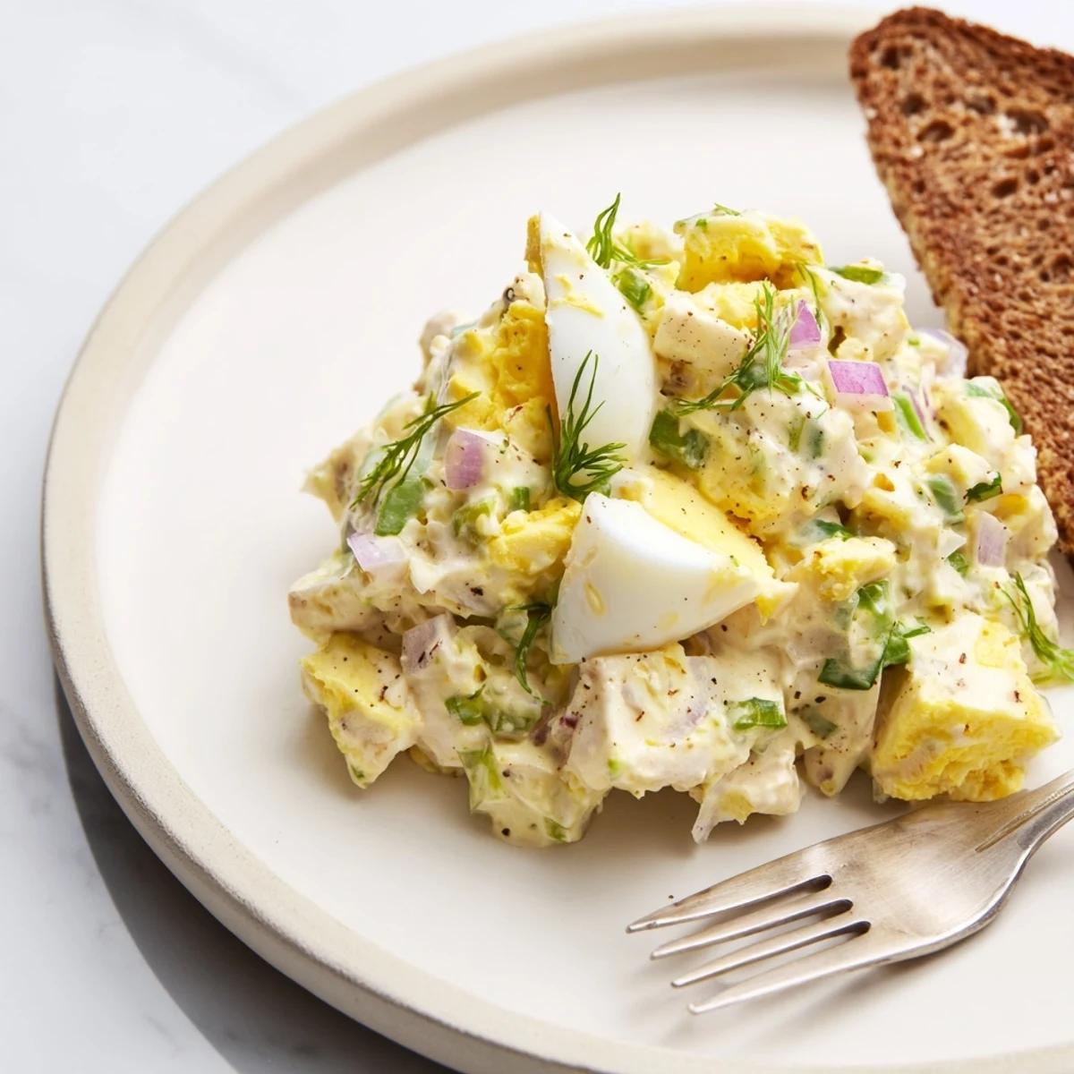 A chilled Classic Egg Salad Recipe spooned into crisp lettuce cups for brunch