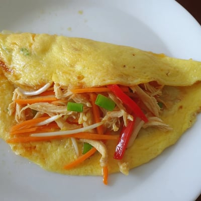 Fluffy Chinese omelette filled with julienned carrots, bean sprouts, and shredded chicken